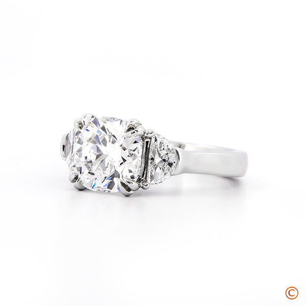 Custom Three Stone Setting featuring a 2.50ct Cushion and Half Moon Sides