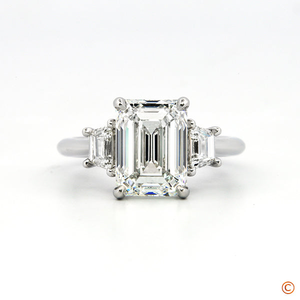 3Stone Ring featuring a 3ct Emerald Cut with Trapezoid Sides