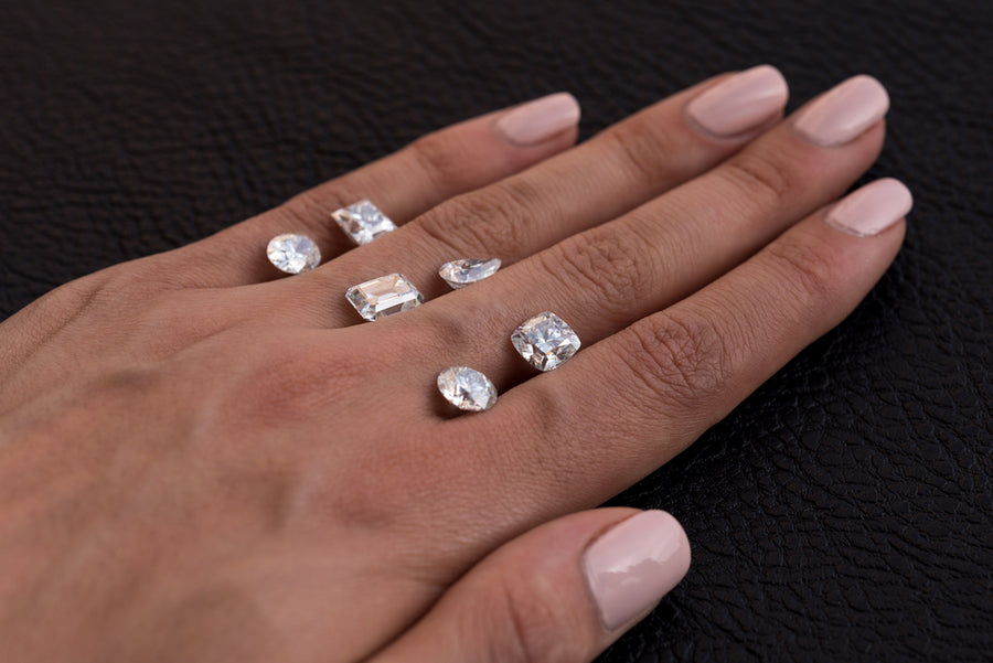 Assortment of Loose Lab Diamonds on a Woman’s Hand