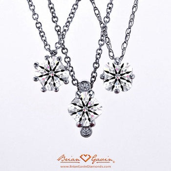 Four prong kite set cushion solitaire diamond pendant