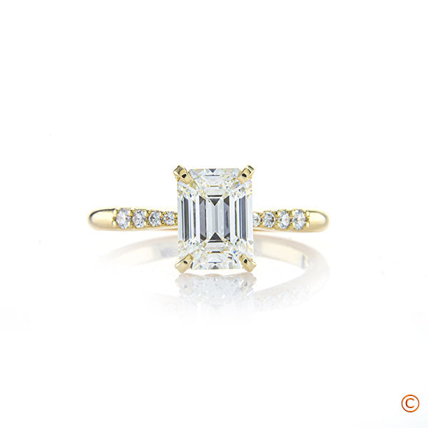 The Sprinkling Novela 18K Yellow Gold Engagement Ring featuring a 1.515 Emerald Cut Diamond!