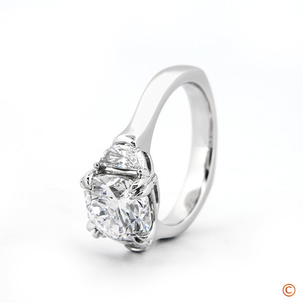 Custom Three Stone Setting featuring a 2.50ct Cushion and Half Moon Sides