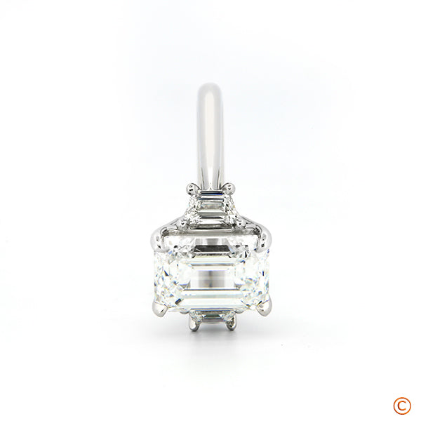 3Stone Ring featuring a 3ct Emerald Cut with Trapezoid Sides