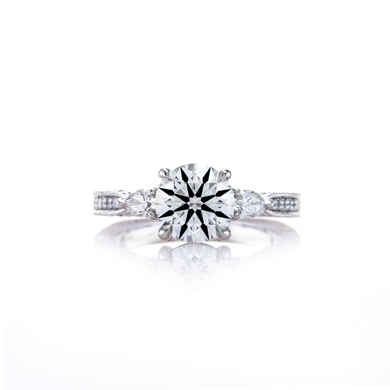 Custom 3 Stone Diamond Ring featuring Pear Shaped Side Stones and Hand Engraving